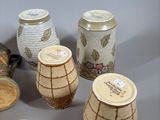 many different types of vases and bowls on the table