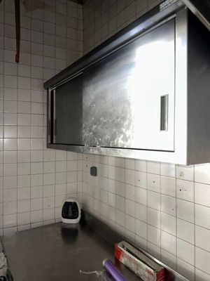 an image of a kitchen with a stove and a microwave