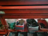 a red shelf with a bunch of tools in it