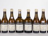 six bottles of wine are lined up in a row on a table