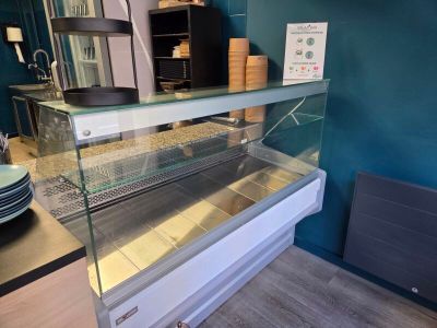 a glass display case in the middle of a kitchen