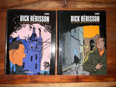 deux livres posés sur une table en bois, avec la photo d'un homme en costume et d'une femme en costume