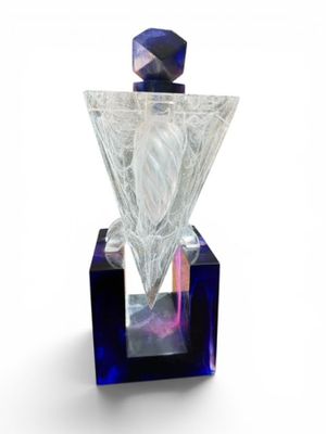 a glass perfume bottle with a diamond on top of it