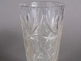 un verre transparent orné d'un motif, posé sur une surface grise