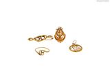 three gold - plated rings and a ring on a white background