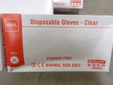two boxes of disposable gloves on a table next to each other