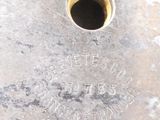 a close up of a metal object with a hole in it