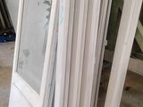 a pile of white doors in the middle of a room