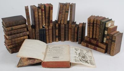 several old books are stacked on top of each other on a table