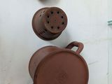 a brown teapot sitting on top of a white counter