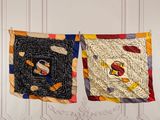 two quilts hanging on a clothes line in a room