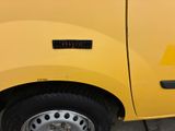 a close up of a yellow truck with a sticker on it