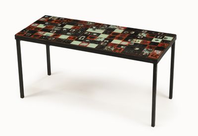 the table is made of black and red tiles with black legs