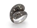 a close up of a ring with black and white diamonds