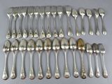 a lot of silver spoons and forks laid out on a table