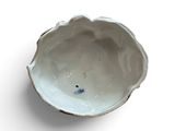 a small white bowl with a blue flower on it