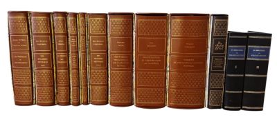 books are lined up in a row on a white surface
