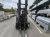 a forklift that is sitting in the middle of a parking lot
