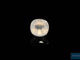 a close up of a white diamond on a black surface