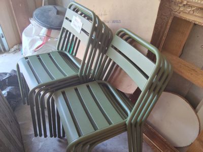 three green chairs sitting next to each other in a room