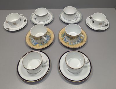 nine cups and saucers sitting on a table