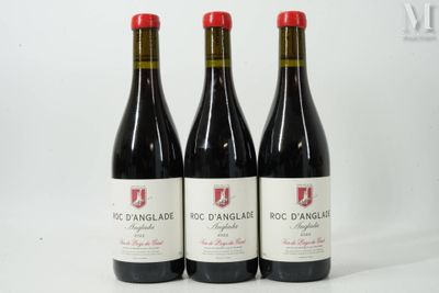 trois bouteilles de vin rouge posées côte à côte sur une table