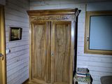 a wooden cabinet in the corner of a room
