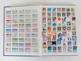 an open book with stamps on it on a table
