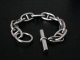 a silver chain bracelet with a silver clasp on a black background