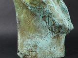 statue of a man ' s head on a black background