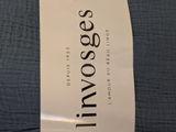 the label of a bed with a blue comforter on top of it
