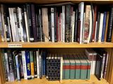 a book shelf with many books on it in a library