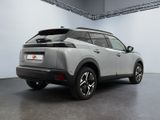 the rear end of a silver suv parked in a garage