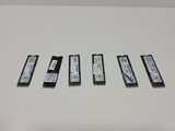 four memory modules are lined up on a white surface