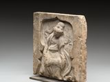an image of a stone relief of a woman and a dog