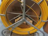 a yellow hose that is on a metal stand