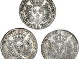 three silver coins, one of which has a crown and the other of which has a crown on it