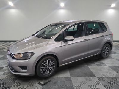 the silver car is parked on a checkered floor in the garage
