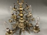 an antique brass chandelier with five lights on a white background