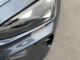a close up of a car ' s headlight and front bumper
