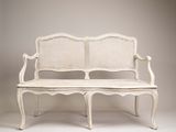 a white bench that is sitting on a white floor