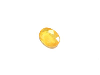 a yellow sapphire stone on a white background