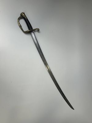 a close up of a sword on a white surface