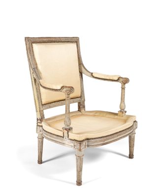 an image of a wooden chair with a beige upholstered seat