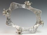 a picture of a silver picture frame with butterflies on it