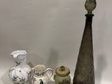 trois vases et un petit vase posés sur une table