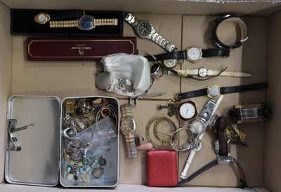 a box filled with assorted items and a watch