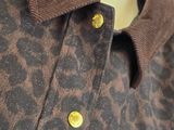 the shirt is brown and black with a leopard print on it