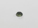 a green tourmaline gemstone on a white surface