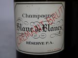 a bottle of wine that has a red stamp on it